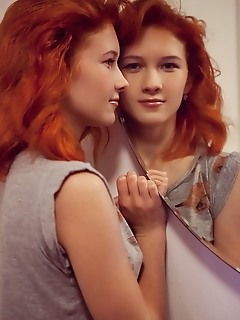 Ambre redhead ambre sensually poses on the bed as she shows off her petite body and smooth pussy.