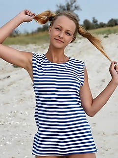 Calli in her striped beach dress and matching pigtails, calli shows off her fun and playful appeal in a beach photo shoot