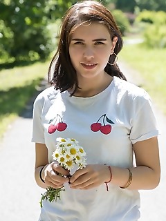 Zhenya mille zhenya mille flaunts her slender body with small tits as she poses in the forest.