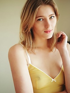 Mila i mila i displays her small tits and smooth pussy on the couch.