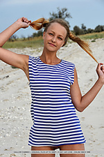 Calli in her striped beach dress and matching pigtails, calli shows off her fun and playful appeal in a beach photo shoot